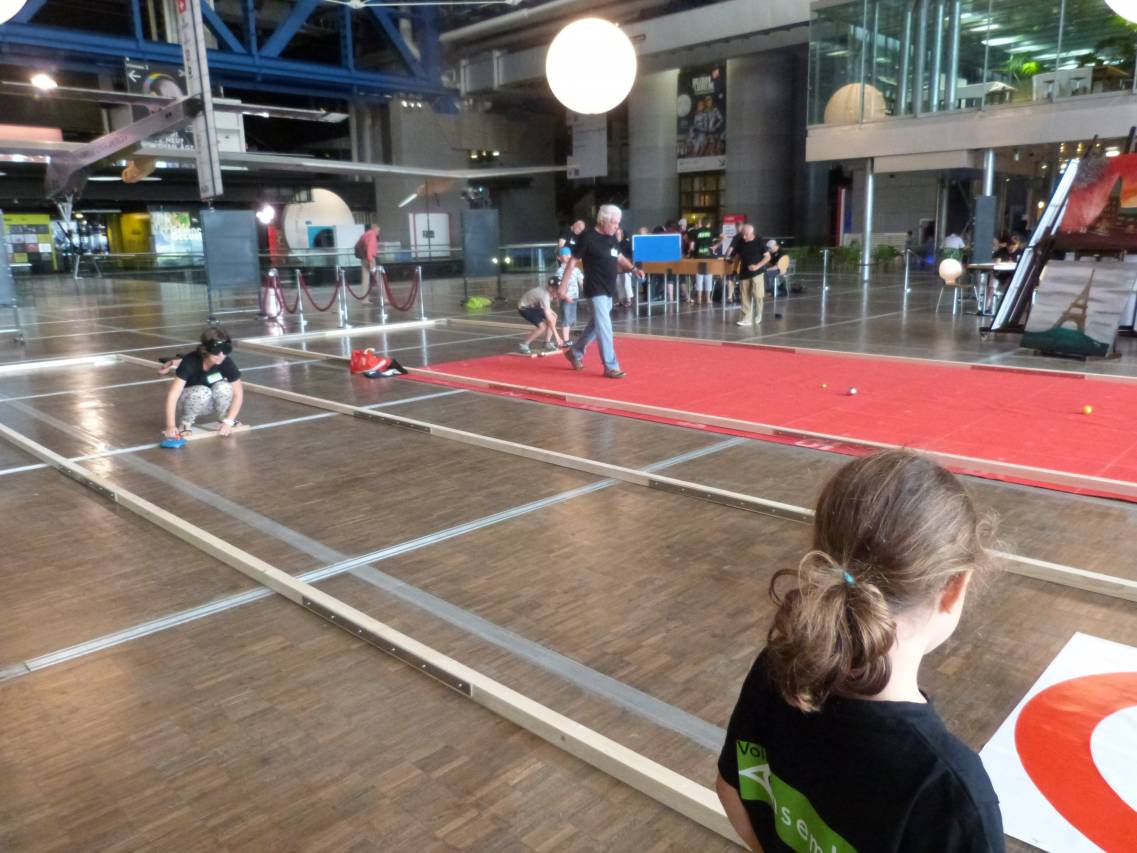 Photo d'une partie de pétanque adaptée lors des 90 ans de Voir Ensemble à la Cité de la Villette (Paris)